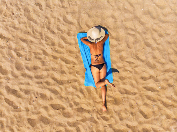 istock Woman lying on the beach 1327664555