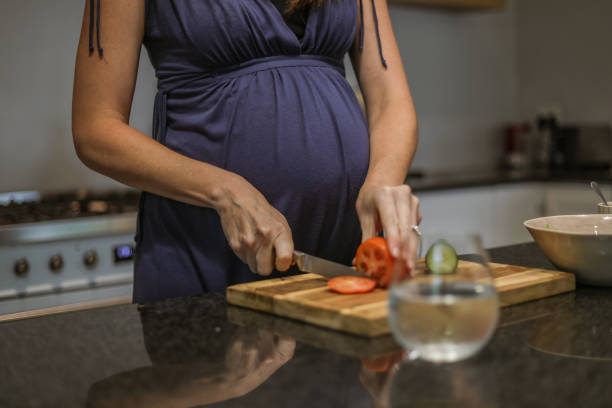 istock Pregnant woman cooking 1327665574