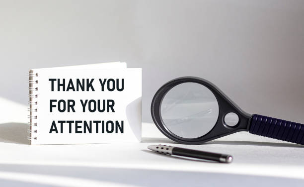 istock Thank you for your attention - a notebook is on a white background, next to a magnifying glass and a pen 1327669868