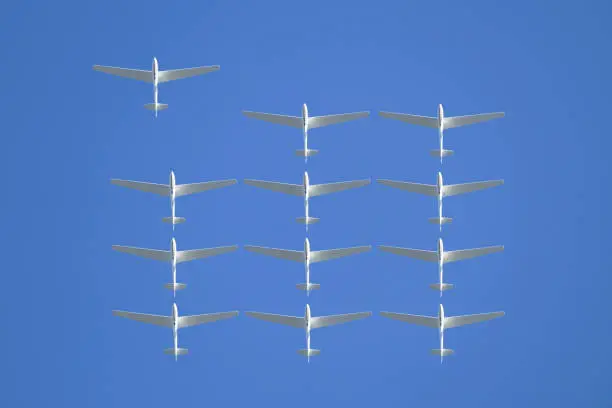 Photo of Formation of gliders on blue sky