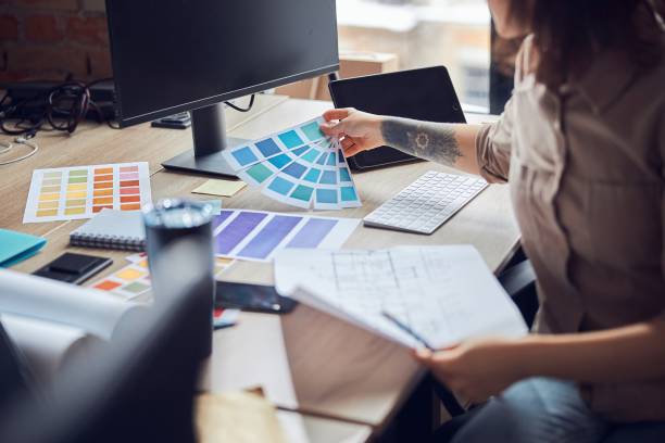 istock Woman choosing color samples palette while working on new interior design project in her office 1327671474