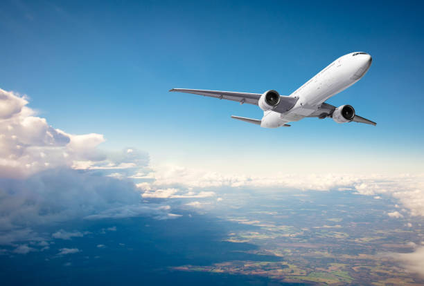 istock Commercial airplane flying above clouds on blue sky background 1327672801
