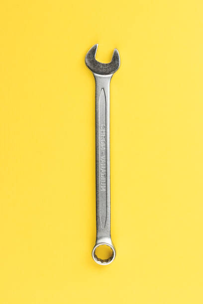 istock Wrench on yellow paper background 1327675005
