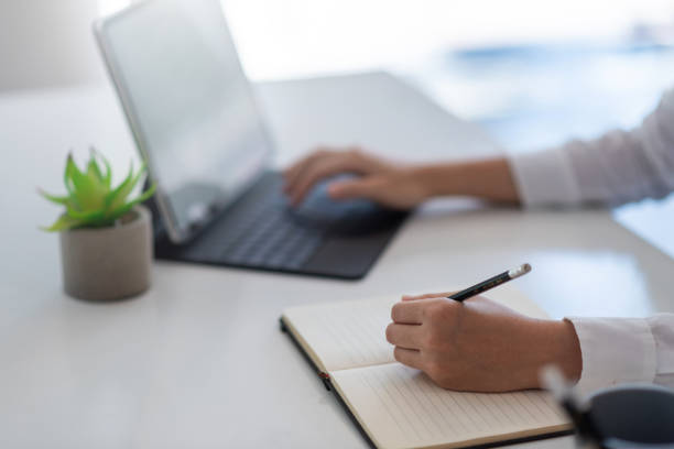 istock Businesswoman taking notes and working with laptop at office. 1327677816