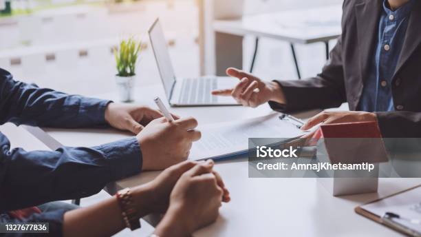 Signing A Business Contract A Group Of Business People Meeting And Signing An Investment Buying And Selling Home And Real Estate Agreement Stock Photo - Download Image Now