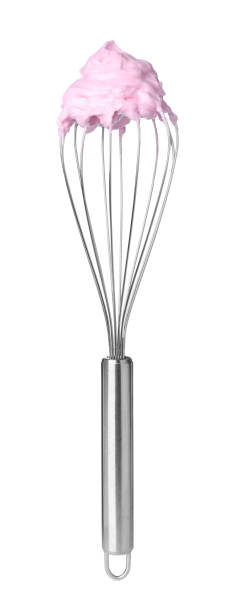 istock Balloon whisk with pink cream isolated on white 1327678849
