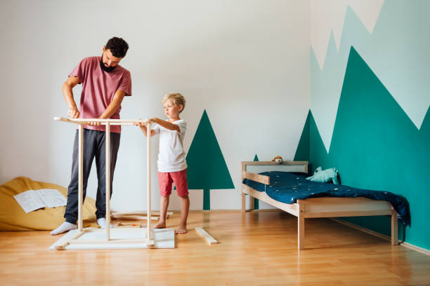 Father And Son Working On Carpentry At Home
