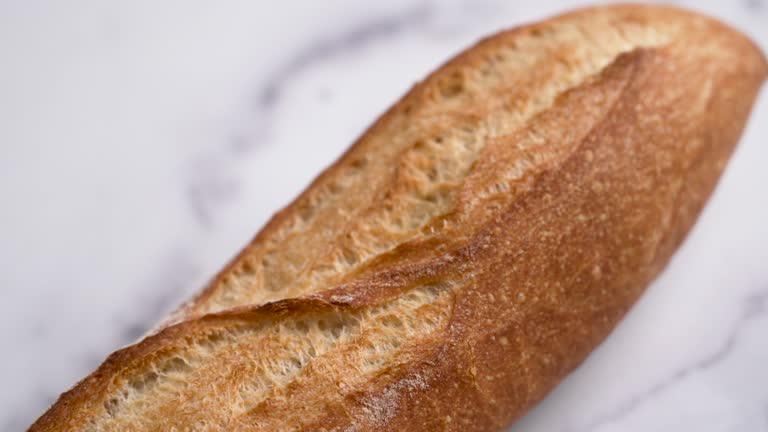 Organic French baguette on white background