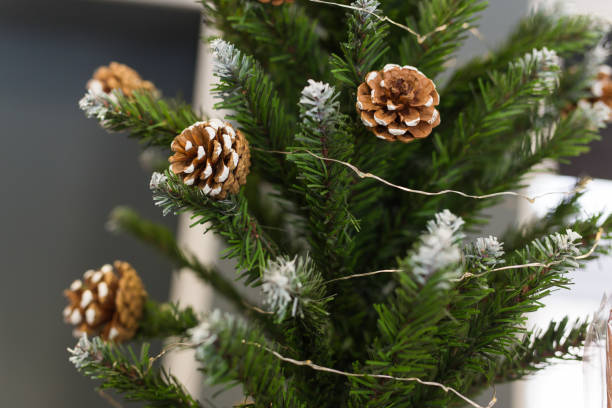 istock Festive an artificial Christmas tree with cones and without decorations. 1327679240