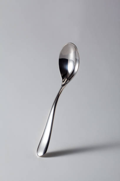 Italian Coffee Spoon from Bar (Cafeteria), Isolated on Gray Background Italian Coffee Spoon from Bar (Cafeteria), Isolated on Gray Background – Original Shiny Silverware from Italian Bar, with Shadow and Reflection – Detailed Close-Up Macro, High Resolution baby spoon stock pictures, royalty-free photos & images
