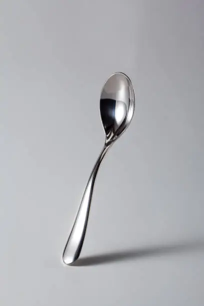 Italian Coffee Spoon from Bar (Cafeteria), Isolated on Gray Background – Original Shiny Silverware from Italian Bar, with Shadow and Reflection – Detailed Close-Up Macro, High Resolution