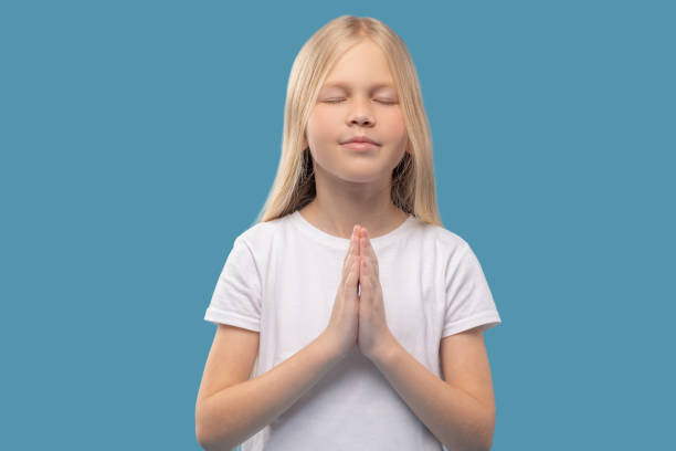 istock Calm girl holding touching palms at chest level 1327679943