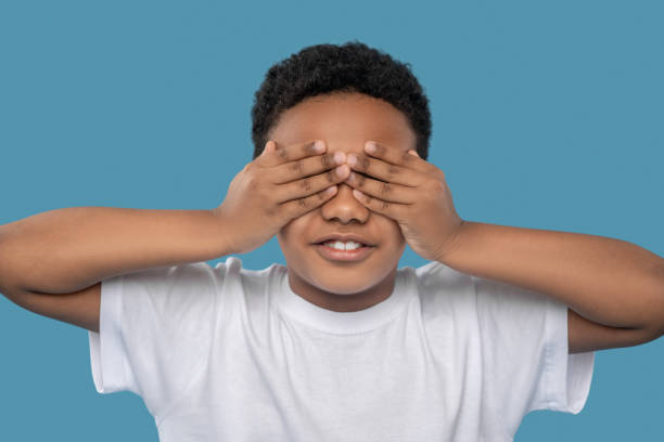 istock African american boy covering eyes with his hands 1327679973