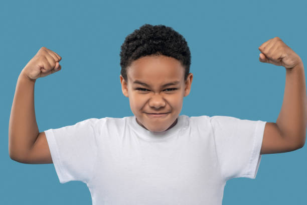 istock African American boy showing his strength 1327680033