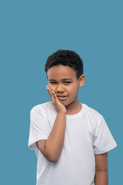 istock Sad african american boy holding cheek 1327680052