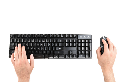 Directly above male hands using computer keyboard and computer mouse (Clipping Path) on the white background