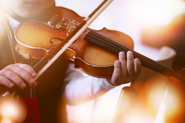 istock Child playing the violin in  room 1327680639