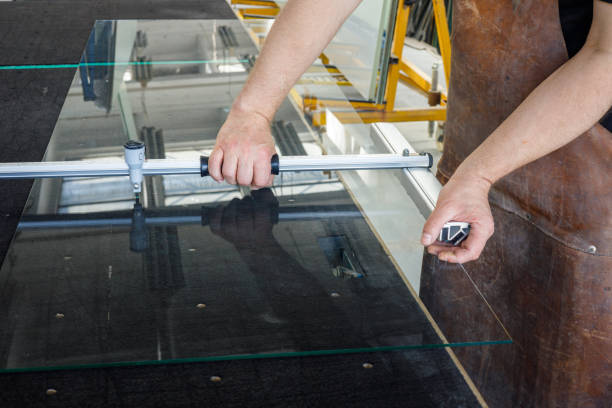 istock The glazier cuts a large sheet of glass. Glass workshop, Specialist work tools 1327681438