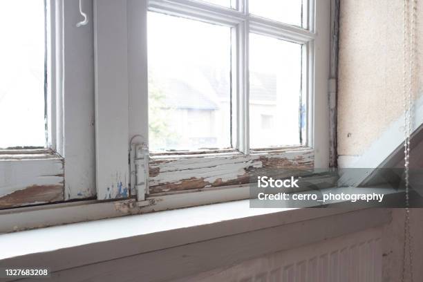 Old Wooden Window Frames With Rotting Wood And Cracked Peeling Paint House Needs Renovation And New Frames Stock Photo - Download Image Now
