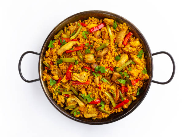 istock spanish paella rice with chicken on white background 1327684339
