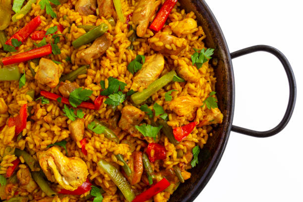 Close-up of spanish paella Arroz con pollo with chicken on white background stock photo