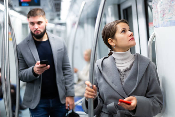 istock Woman with smartphone in subway car 1327684773