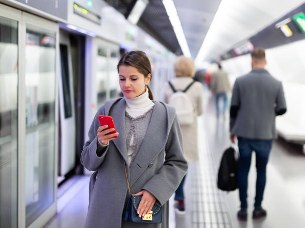 istock Woman reads sms message at subway station 1327685478