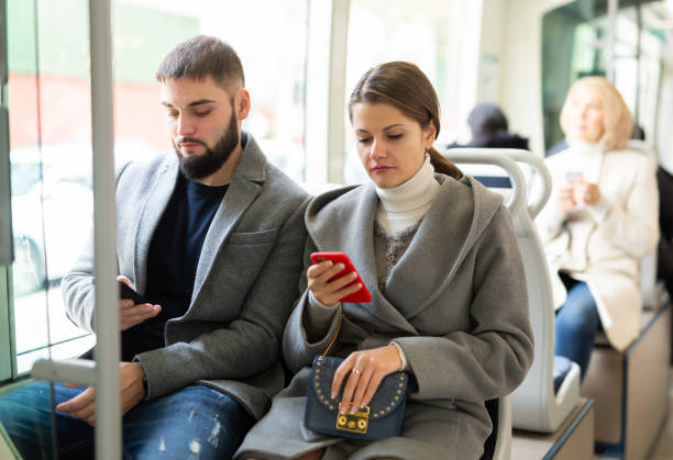 istock People browsing in smartphone in bus 1327685486