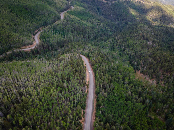 Drone View of Winding Mountain Road in Sangre De Cristo Mountains near Santa Fe, New Mexico Drone View of winding mountain road in Sangre De Cristo Mountains in the Santa Fe National Forest near Santa Fe, New Mexico in the summer. los alamos new mexico stock pictures, royalty-free photos & images