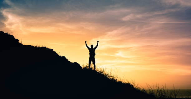 istock Man hiker celebrating his successful climbing trip 1327685857