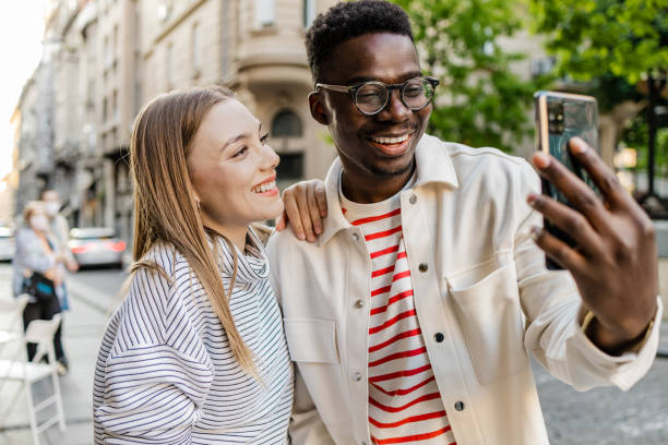 istock Friends taking selfie on the street 1327685946