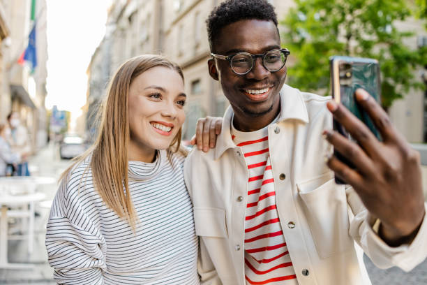 istock Friends taking selfie on the street 1327686599