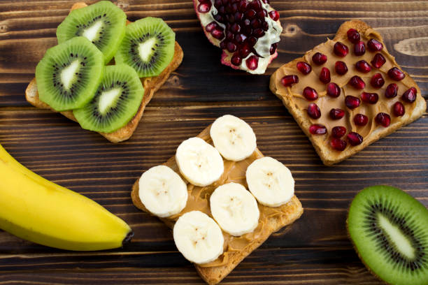 istock Toasts with peanut paste and fruit on the wooden background 1327686667