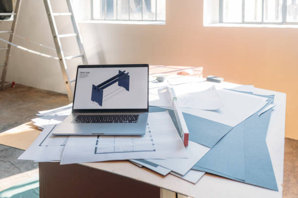 istock Model of a Table with Blueprints and Laptop on the Table 1327686965