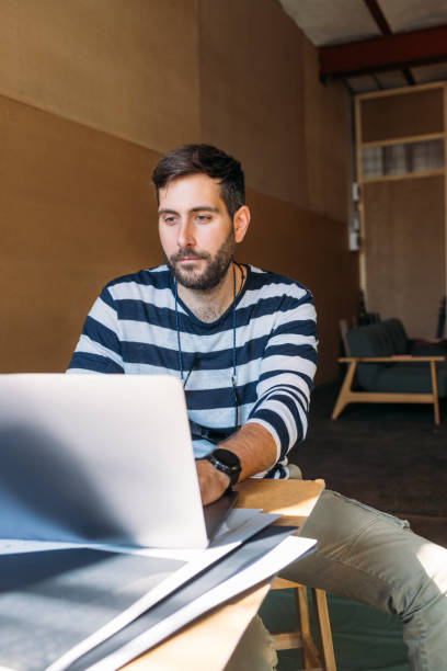 istock Male Designer Working on his Laptop Computer 1327686974
