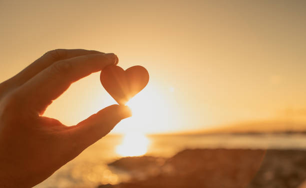 istock Heart on the beach at sunset 1327687244