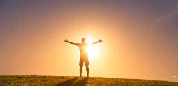 istock Man enjoying beautiful sunset. Success, hope, achievement concept. 1327687913