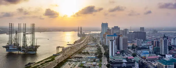 A panorama shot of a Landscape showing the coastline of Lagos Island, Nigeria at sunset, the Atlantic and a rig