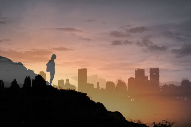 istock Hiker on a mountain looking at the city from a far. 1327688283
