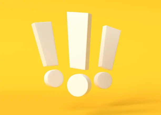 Photo of Group of white exclamation marks on yellow background