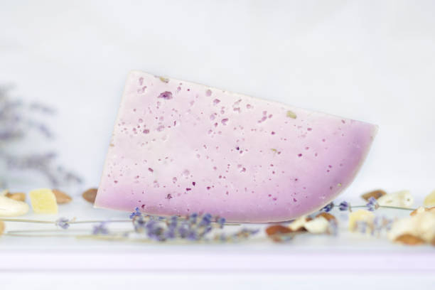 istock Lavender cheese closeup on a white background. Exotic flavor. 1327691188