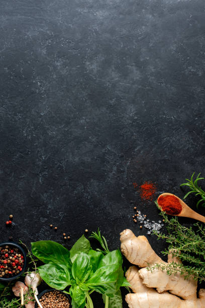 istock Fresh herbs, herbs, ginger and spices on a black background with copy space. Culinary concept. 1327691554
