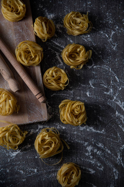 istock Italian Pasta on Dark Wooden Table 1327691769