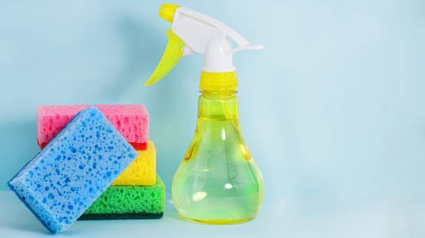 istock colorful sponges and spray on a blue background. Cleaning concept. Copy space 1327695666