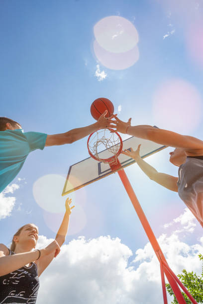 istock Friends playing basketball game on a sunny day 1327697089