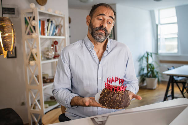 istock Mature man celebrating his birthday on a video call 1327697954