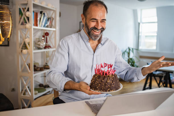 istock Mature man celebrating his birthday on a video call 1327698030