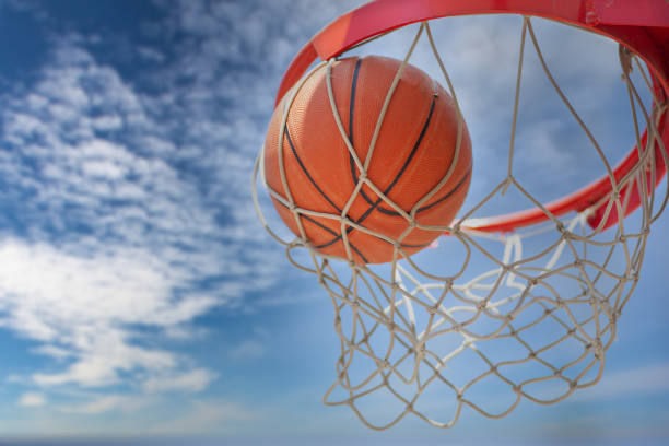 istock A basketball swishes through the net 1327698111