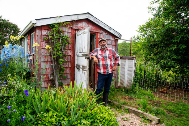 istock A man standing outside a beautiful rustic chicken coop 1327699102
