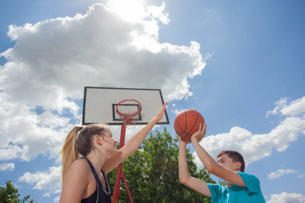 istock Friends playing basketball game on a sunny day 1327699109